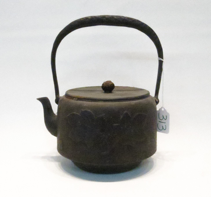 Appraisal: JAPANESE CAST IRON TEAPOT with bale handle the body adorned