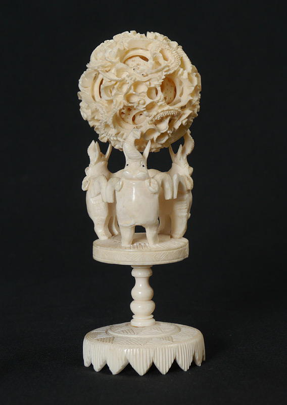 Appraisal: CARVED IVORY MYSTERY BALL STAND Mystery ball with dragon motif