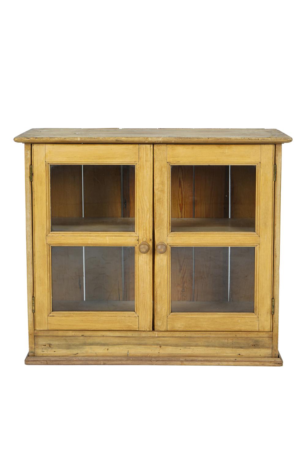 Appraisal: SMALL RUSTIC PINE CABINETwith two hinged glazed doors enclosing a