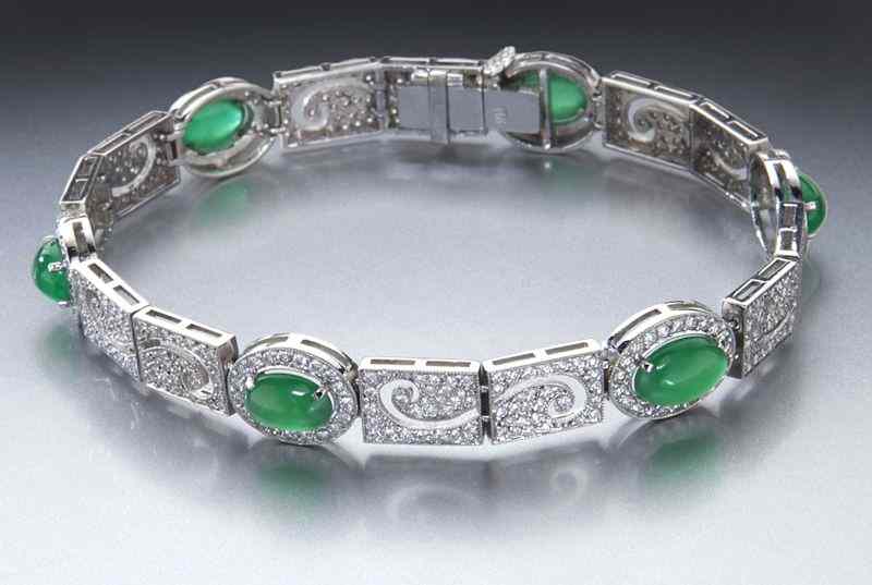 Appraisal: K gold jadeite and diamond braceletfeaturing oval translucent green jadeite