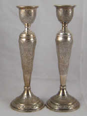 Appraisal: A pair of Persian silver standard baluster candlesticks decorated in