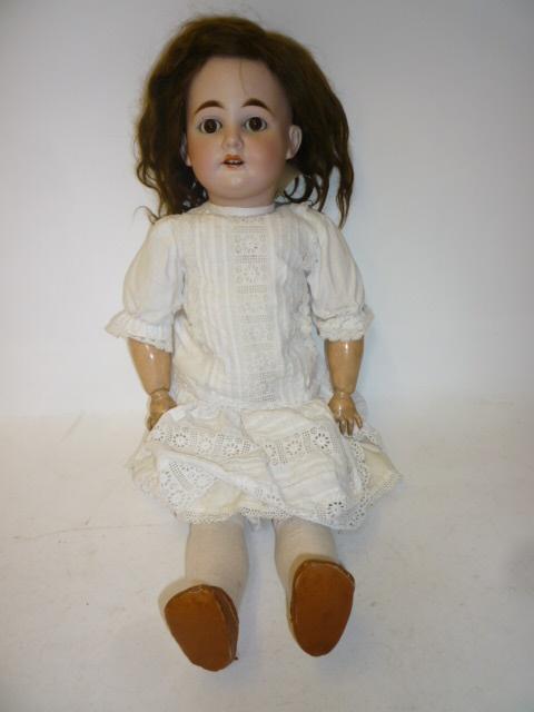 Appraisal: An Armand Marseille bisque head girl doll with brown glass