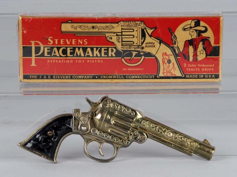 Appraisal: Stevens Gold Peacemaker Cap Gun Description Includes box Box has