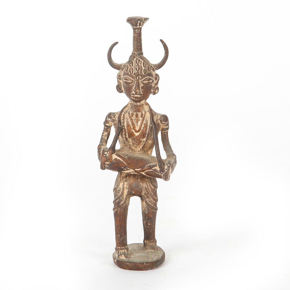 Appraisal: SMALL BRONZE SCULPTURE HORNED DEITY Deity is playing drums has