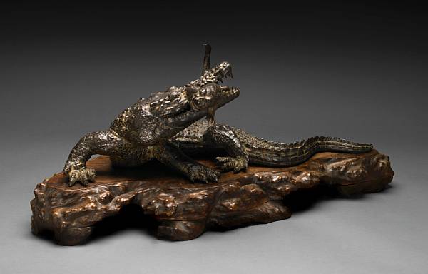 Appraisal: A patinated bronze model of a crocodile Modeled with a