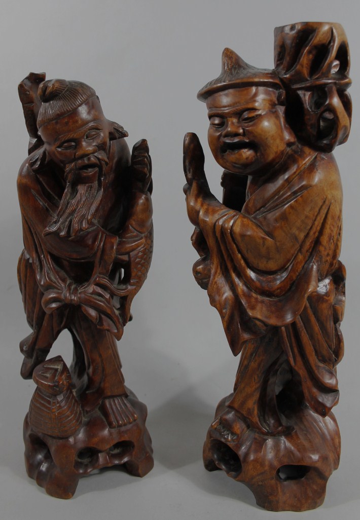 Appraisal: Two Chinese hardwood figures each partially stained the first a