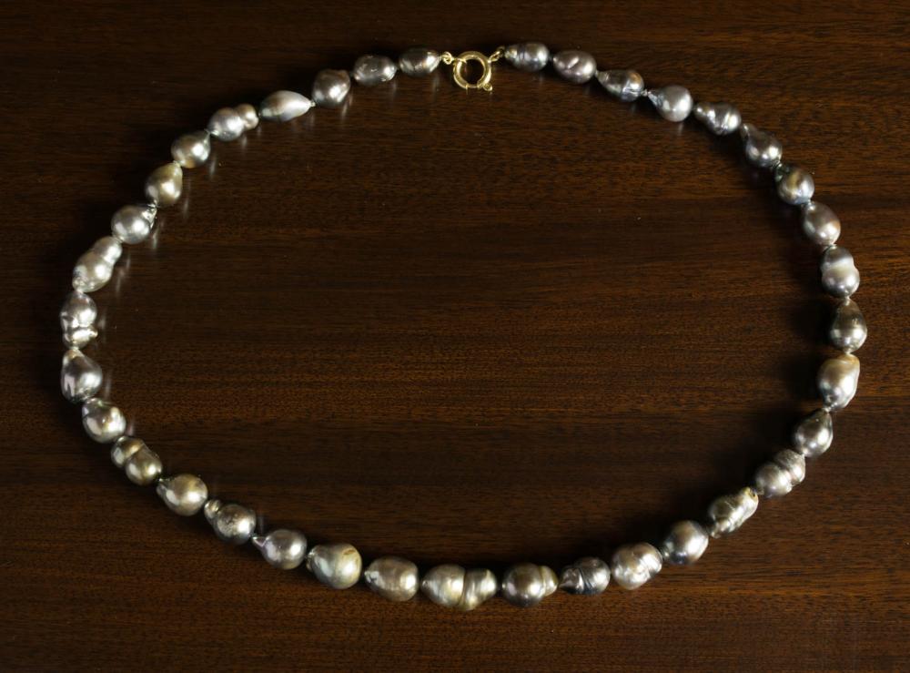 Appraisal: BAROQUE BLACK PEARL AND EIGHTEEN KARAT GOLD NECKLACE strand of