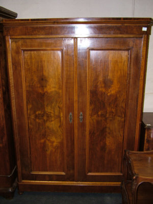 Appraisal: A walnut Armoire the moulded cornice above two panelled doors