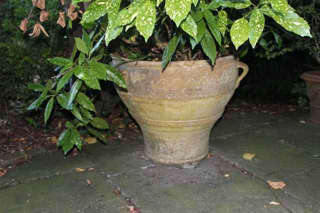 Appraisal: A TERRACOTTA PLANTER WITH with Greek impressed stamp and three