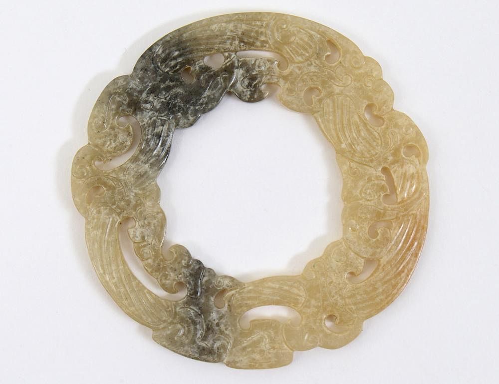 Appraisal: PIERCED JADE DOUBLE-DRAGON BI DISC The russet and gray circular