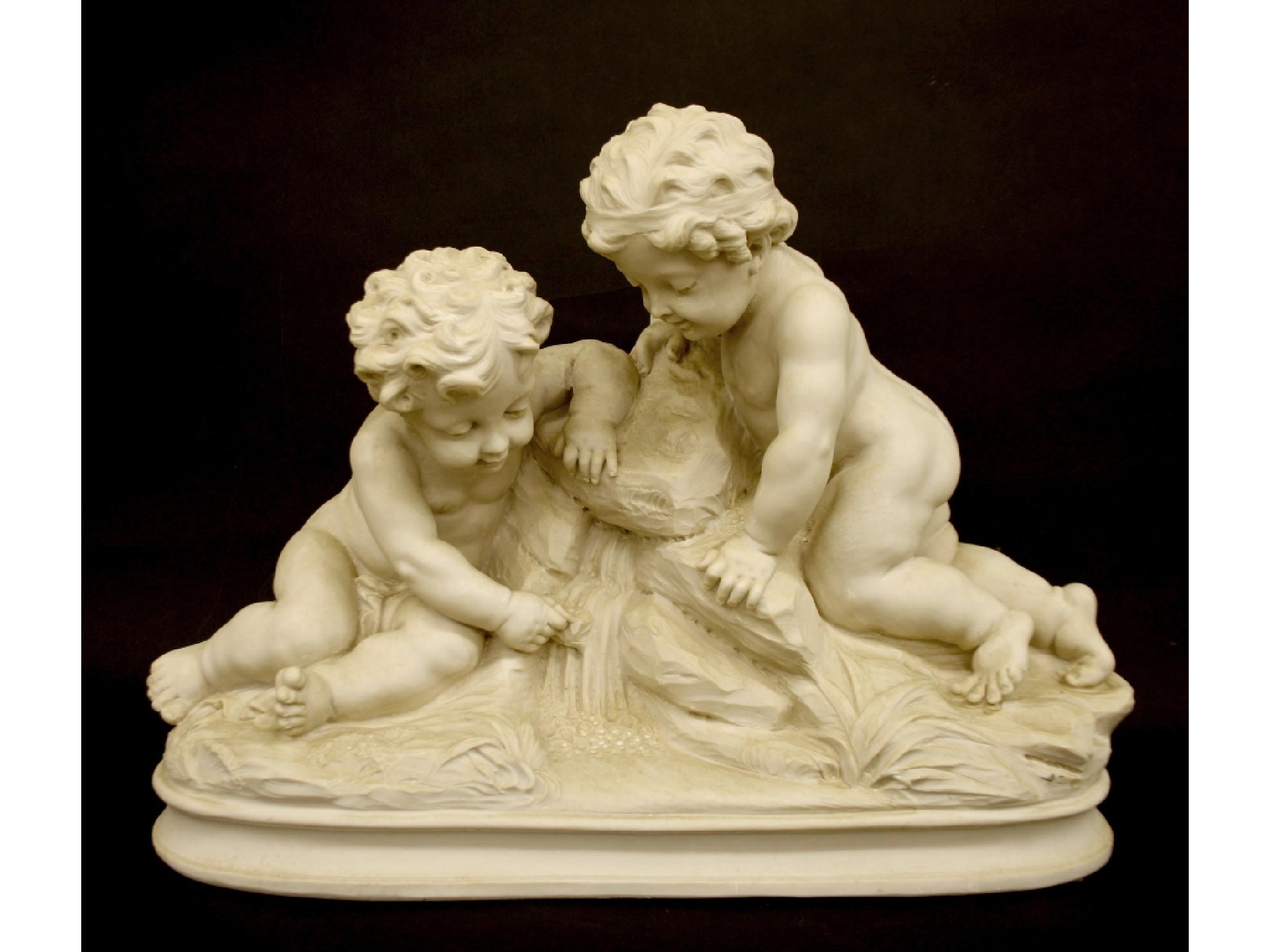 Appraisal: Faux marble resin study of two cherubs on a rocky