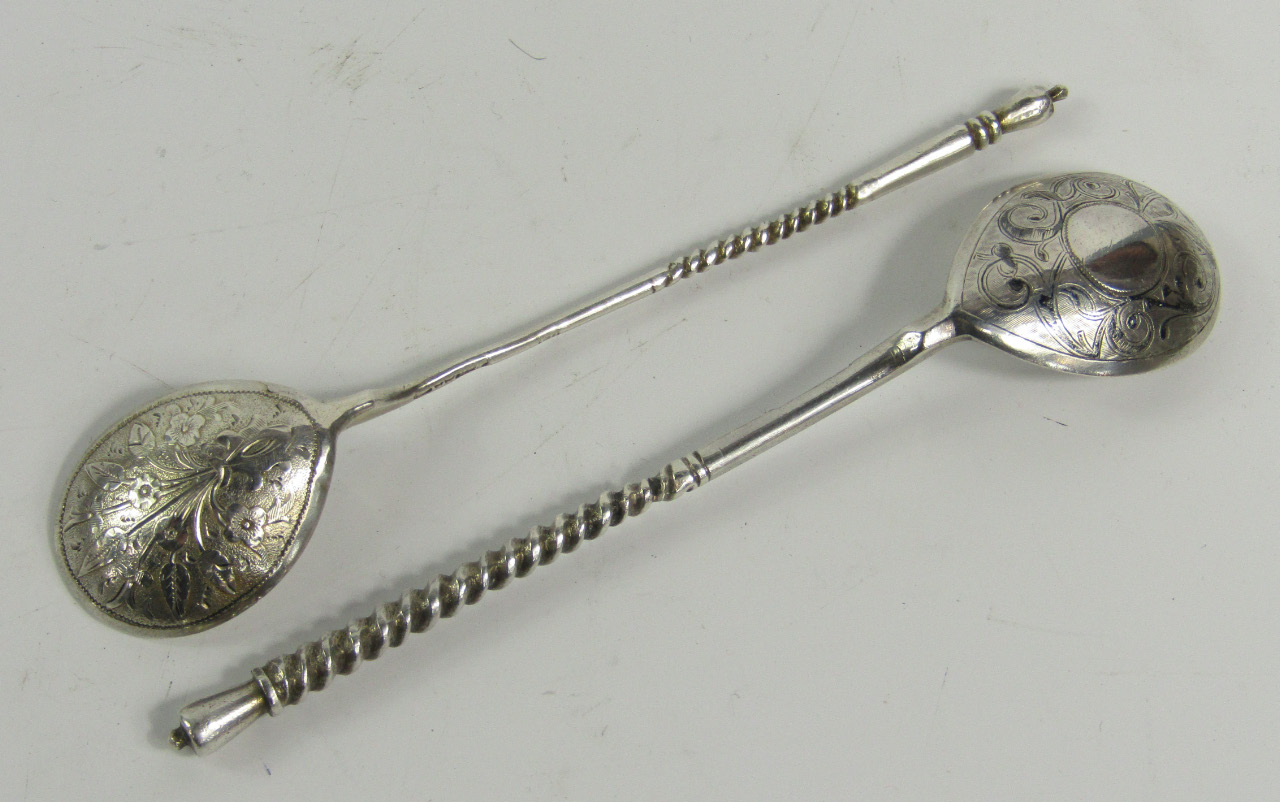 Appraisal: Two Russian white metal spoons with turned shafts and engraved