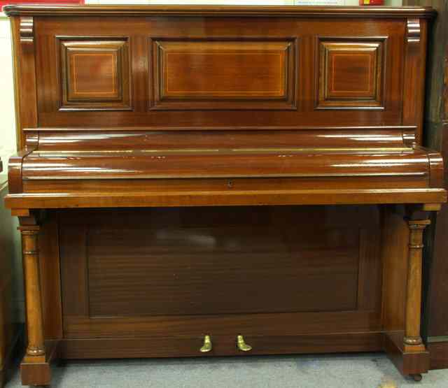 Appraisal: An upright piano in a mahogany case