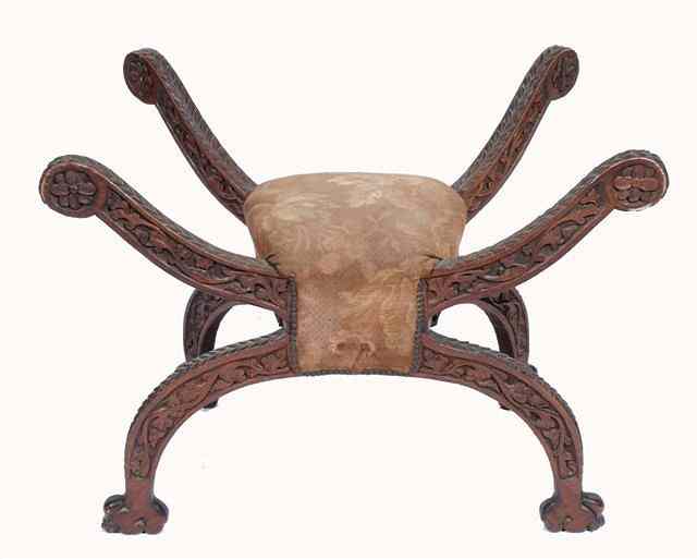 Appraisal: A MIDDLE EASTERN CARVED WOODEN SPIDER STOOL with upholstered seat