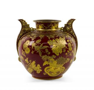 Appraisal: A CONTINENTAL GILT PAINTED PORCELAIN VASE RETAILED BY BAILEY BANKS