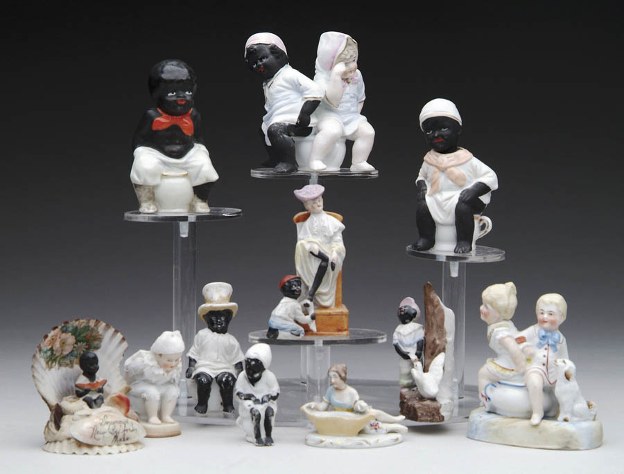 Appraisal: ELEVEN FIGURINES Eight black figurines and three others Five have