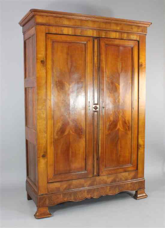 Appraisal: A th century French cherrywood armoire with two panelled doors