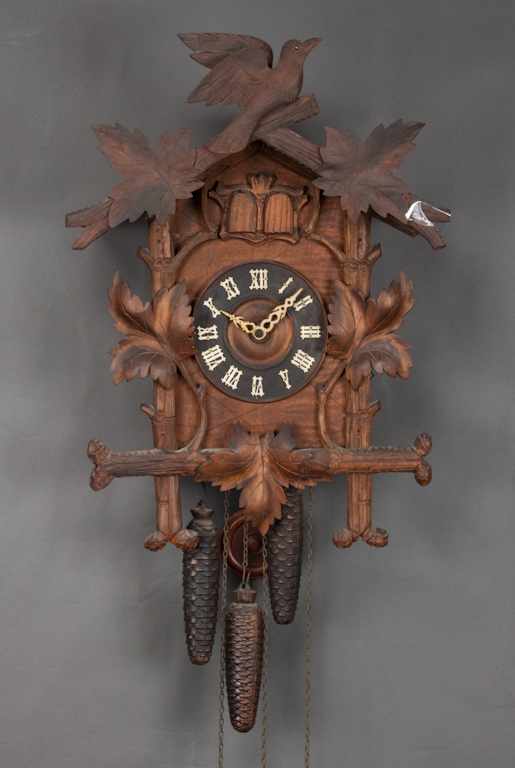 Appraisal: German Black Forest carved walnut cuckoo clock carved bird and