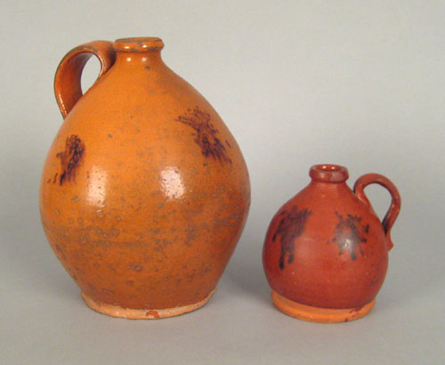 Appraisal: Two redware ovoid jugs th c with manganese splash decoration