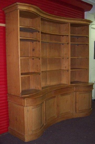 Appraisal: A serpentine front pine bookcase with moulded cornice above three