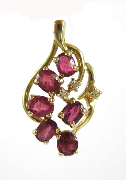 Appraisal: RUBY AND FOURTEEN KARAT GOLD PENDANT set with three round-cut