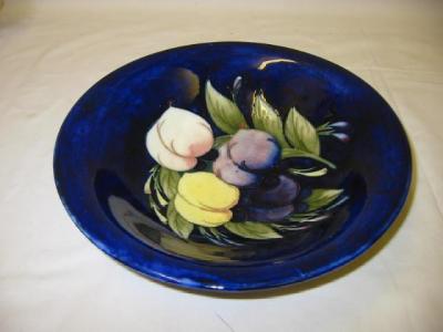 Appraisal: A WALTER MOORCROFT POTTERY BOWL of shallow circular form tube