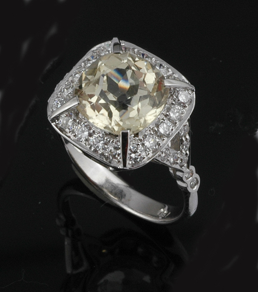 Appraisal: AN ART DECO STYLE YELLOW SAPPHIRE AND DIAMOND RING The