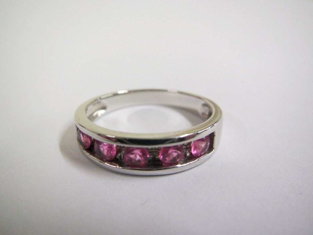 Appraisal: Nine carat white gold pink sapphire half hoop ring