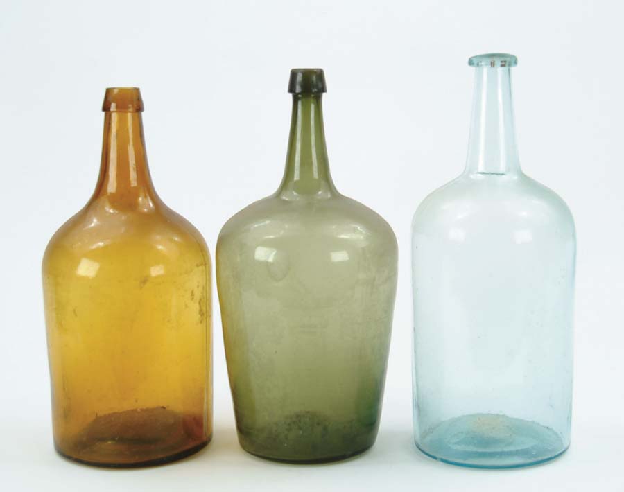 Appraisal: THREE COLORED GLASS DEMIJOHNS Free blown green with pontil mark