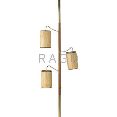 Appraisal: AMERICAN MODERN Three-light pole lamp Brass walnut and grass shades