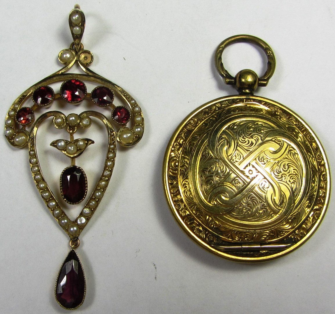 Appraisal: A gold garnet and seed pearl set pendant pierced in