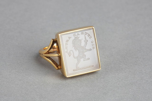 Appraisal: A HARDSTONE SEAL RING with rectangular stone carved with a