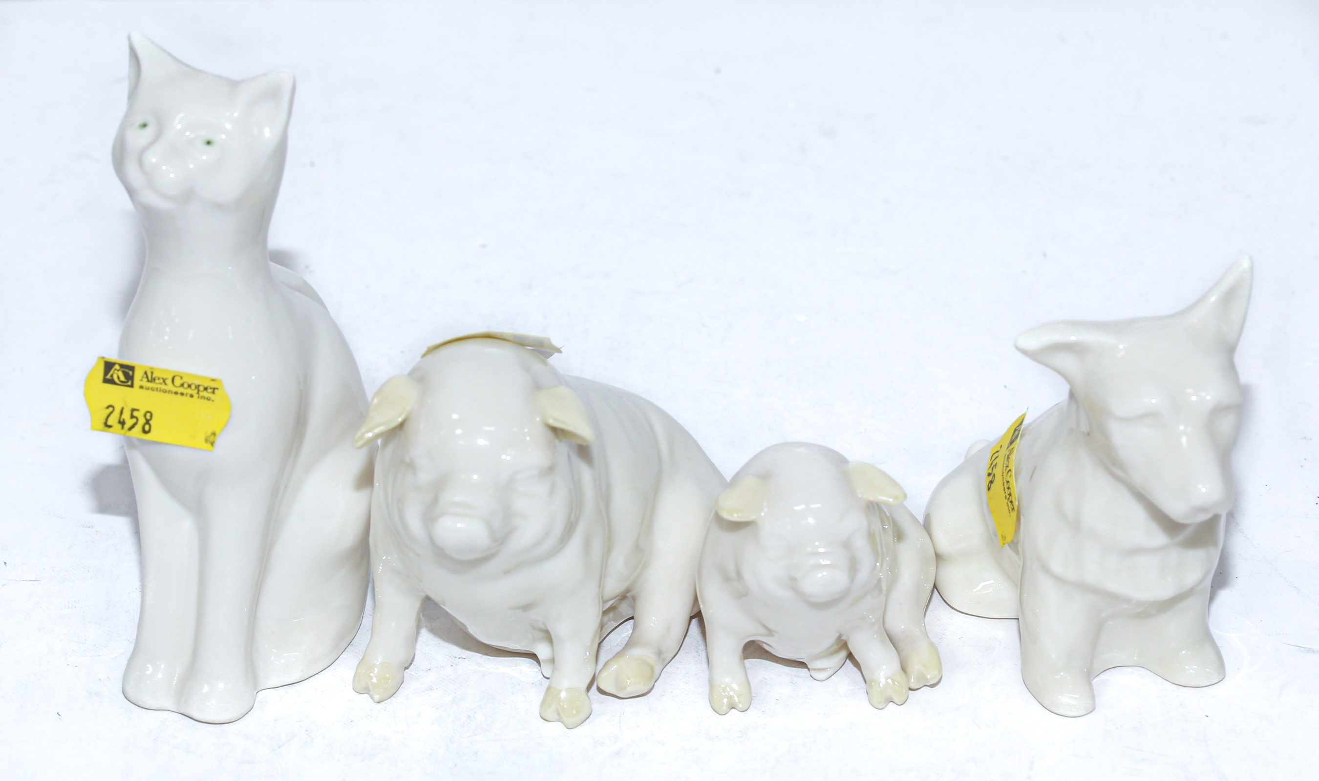 Appraisal: FOUR BELLEEK ANIMAL FIGURES Comprising two pigs to in H