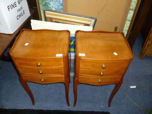 Appraisal: A PAIR OF CONTINENTAL FRUITWOOD BEDSIDE CABINETS each with three