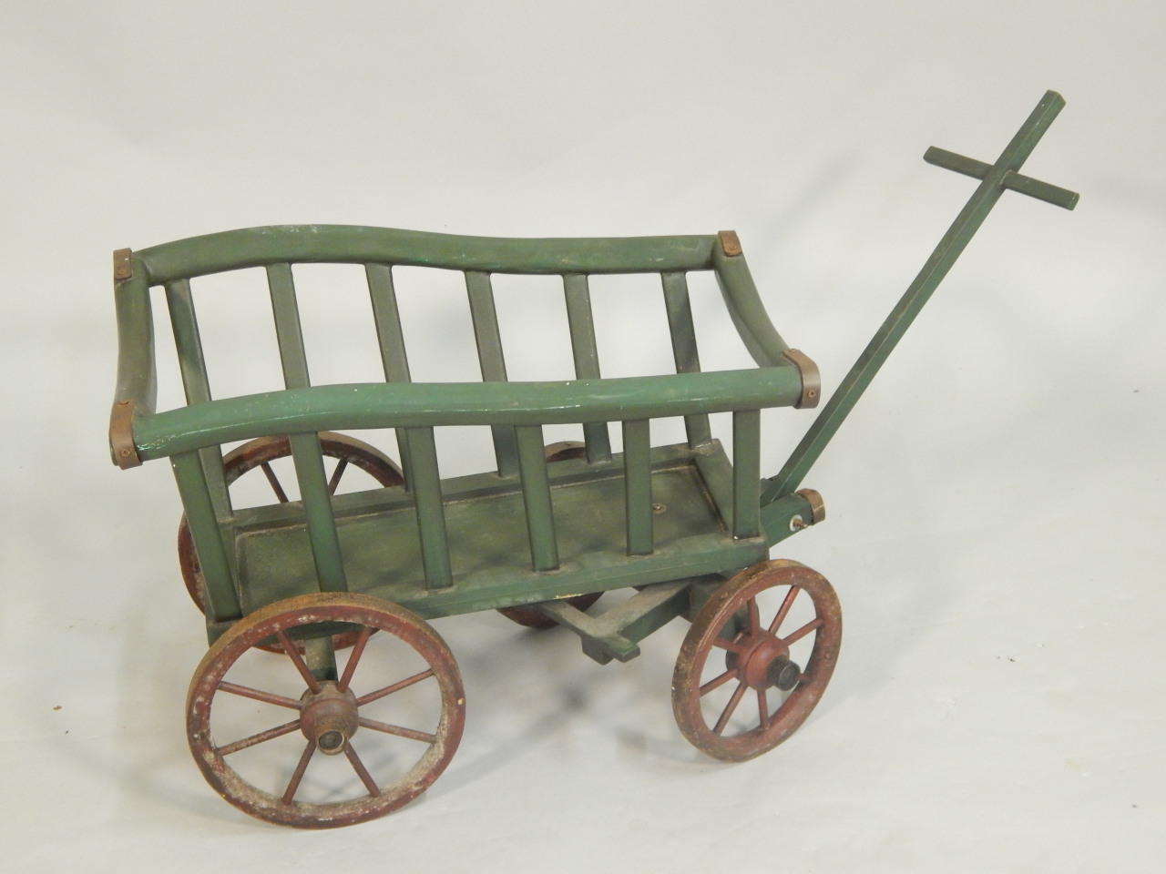 Appraisal: A reproduction green painted child's cart with spoked wheels