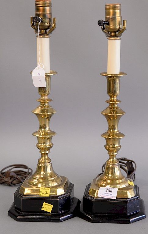 Appraisal: Pair of brass candlesticks made into lamps on ebonized wood