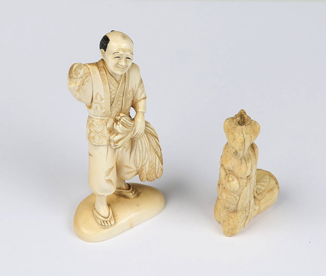 Appraisal: A CARVED IVORY FIGURE of a Japanese farmer gathering maize