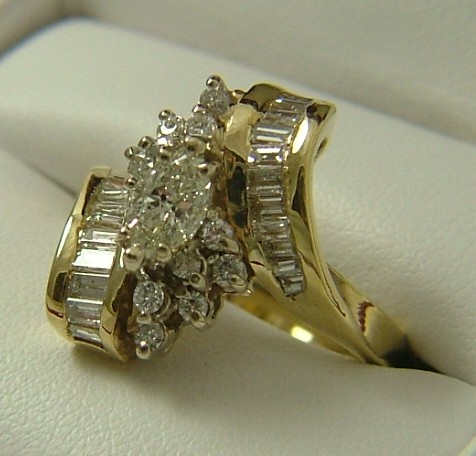 Appraisal: DIAMOND AND FOURTEEN KARAT GOLD RING set with a marquise-cut