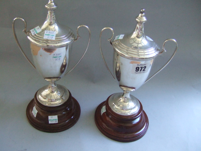 Appraisal: Two similar silver twin handled trophy cups and covers detailed