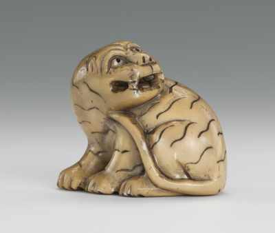 Appraisal: Carved Ivory Netsuke of Tiger Signed Seated tiger with applied