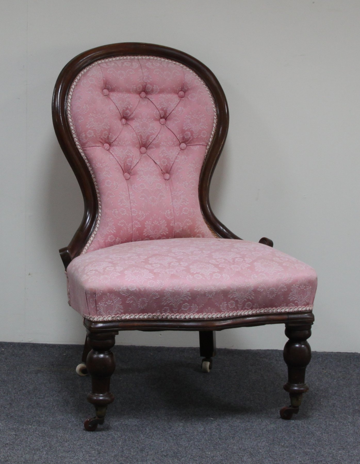 Appraisal: A Victorian lady's fireside chair the carved frame with button