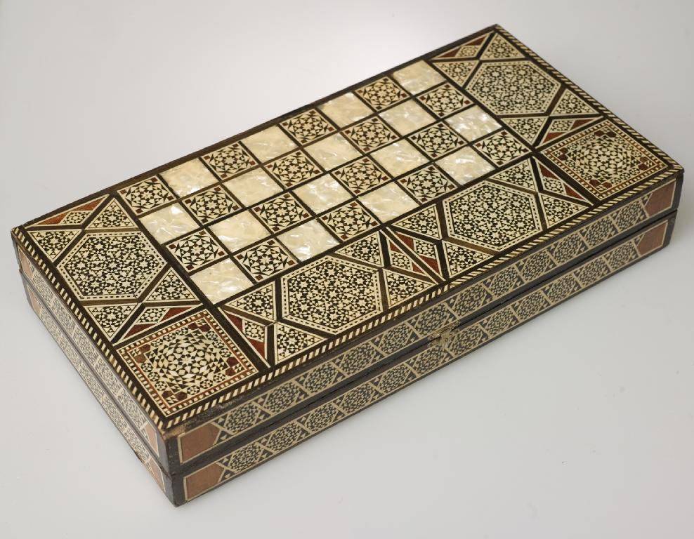 Appraisal: MIDDLE EASTERN BONE AND MOTHER-OF-PEARL INLAID GAMES BOX the exterior