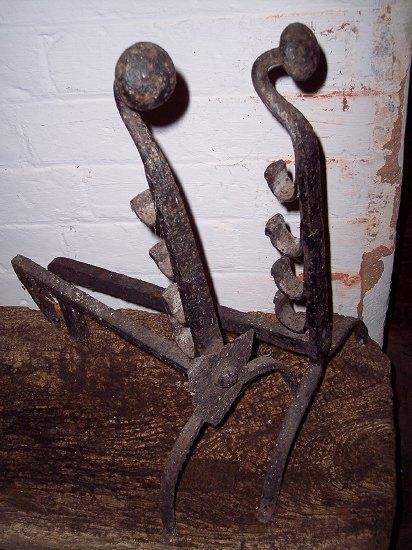 Appraisal: A pair of wrought iron fire dogs with button finials