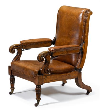 Appraisal: Regency walnut adjustable library armchair The hinged brown leather upholstered