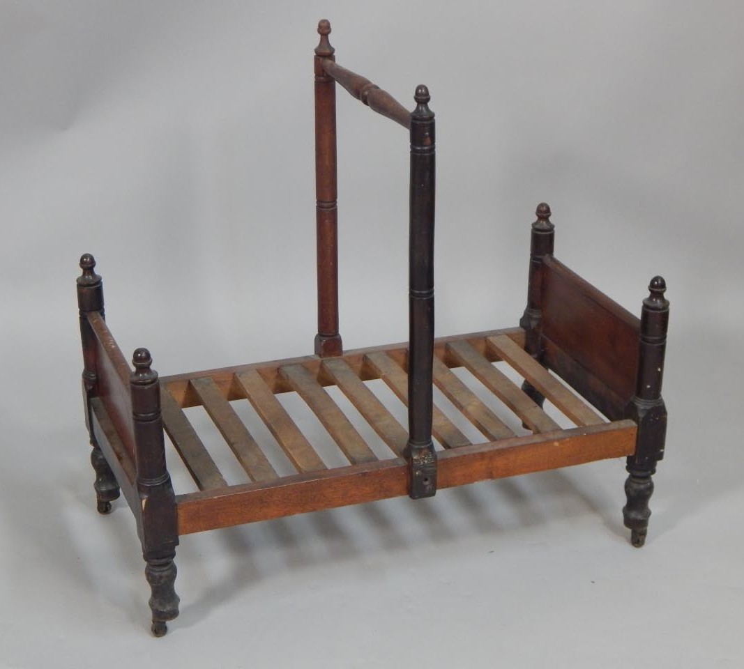 Appraisal: An unusual Victorian mahogany Canterbury or cradle with a turned