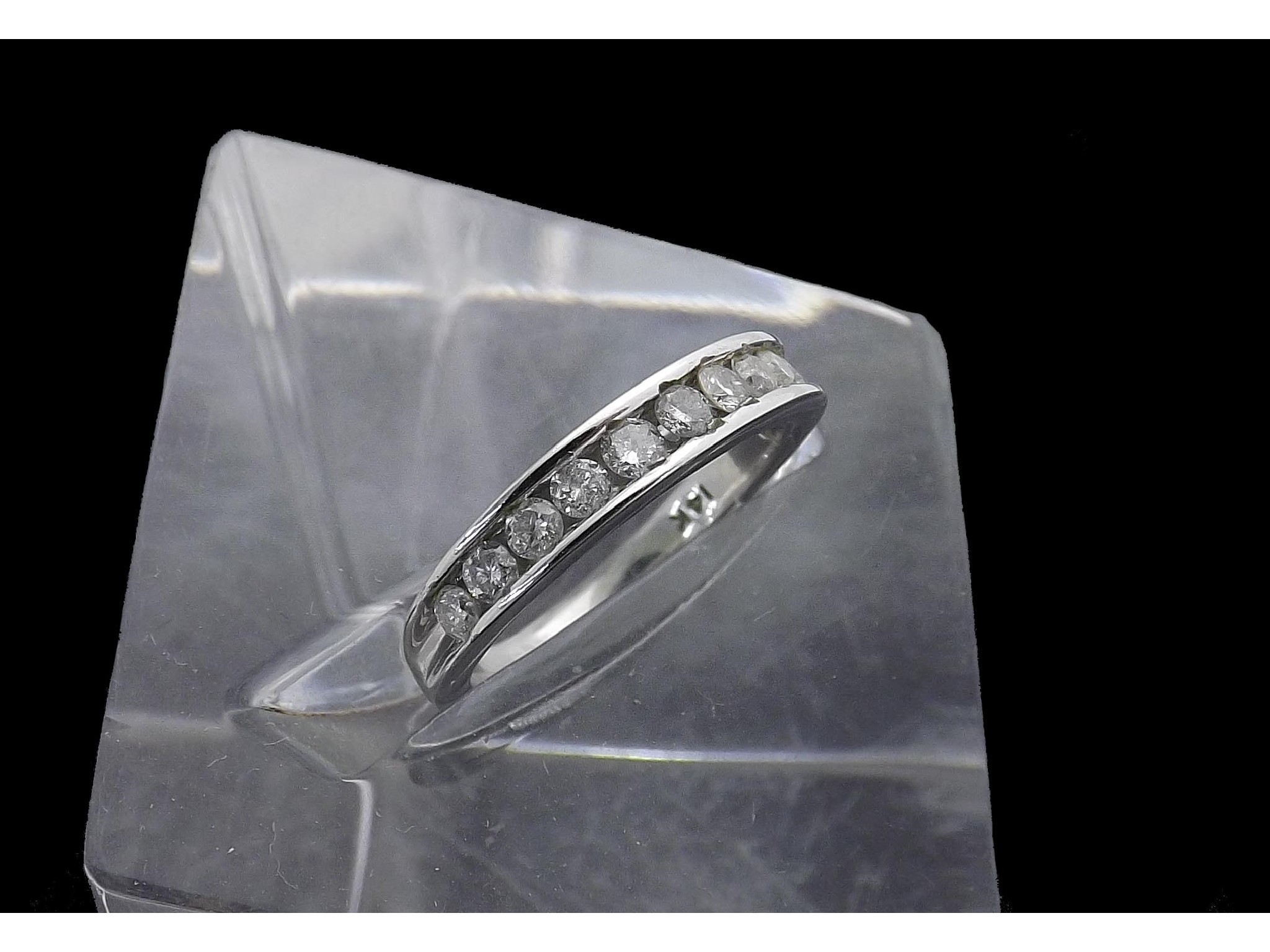 Appraisal: k channel set brilliant-cut diamond half eternity ring gm ring