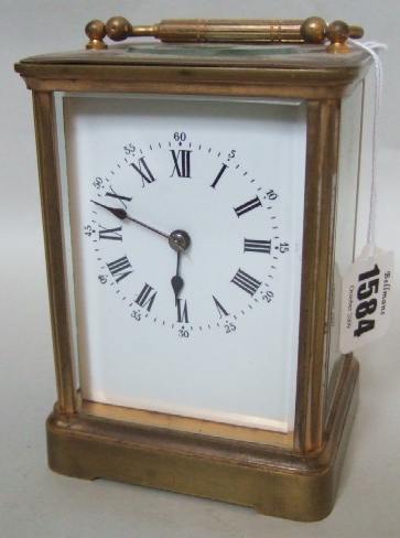 Appraisal: A gilt brass carriage clock with white enameled dial and