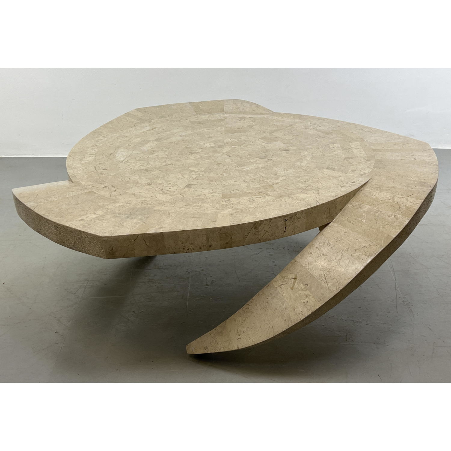 Appraisal: Tesselated Stone Decorator Coffee Table Three curved legs emanate from