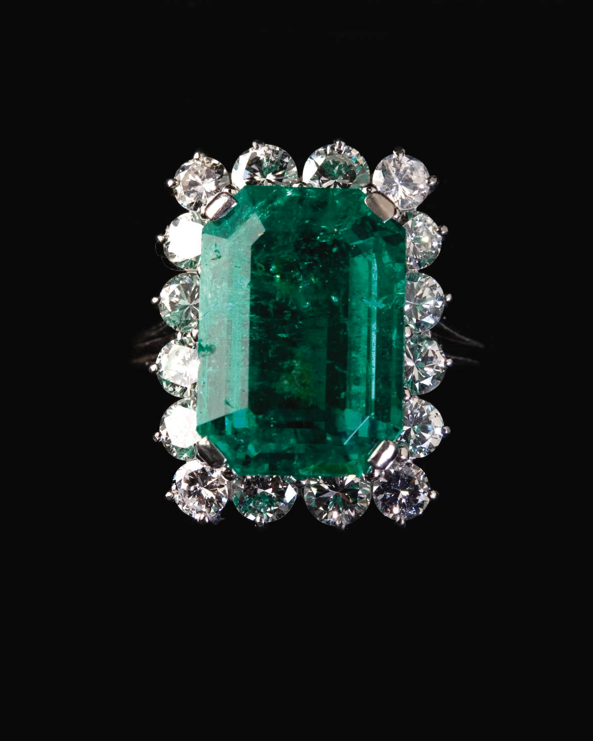 Appraisal: EMERALD AND DIAMOND RING The platinum ring set with a