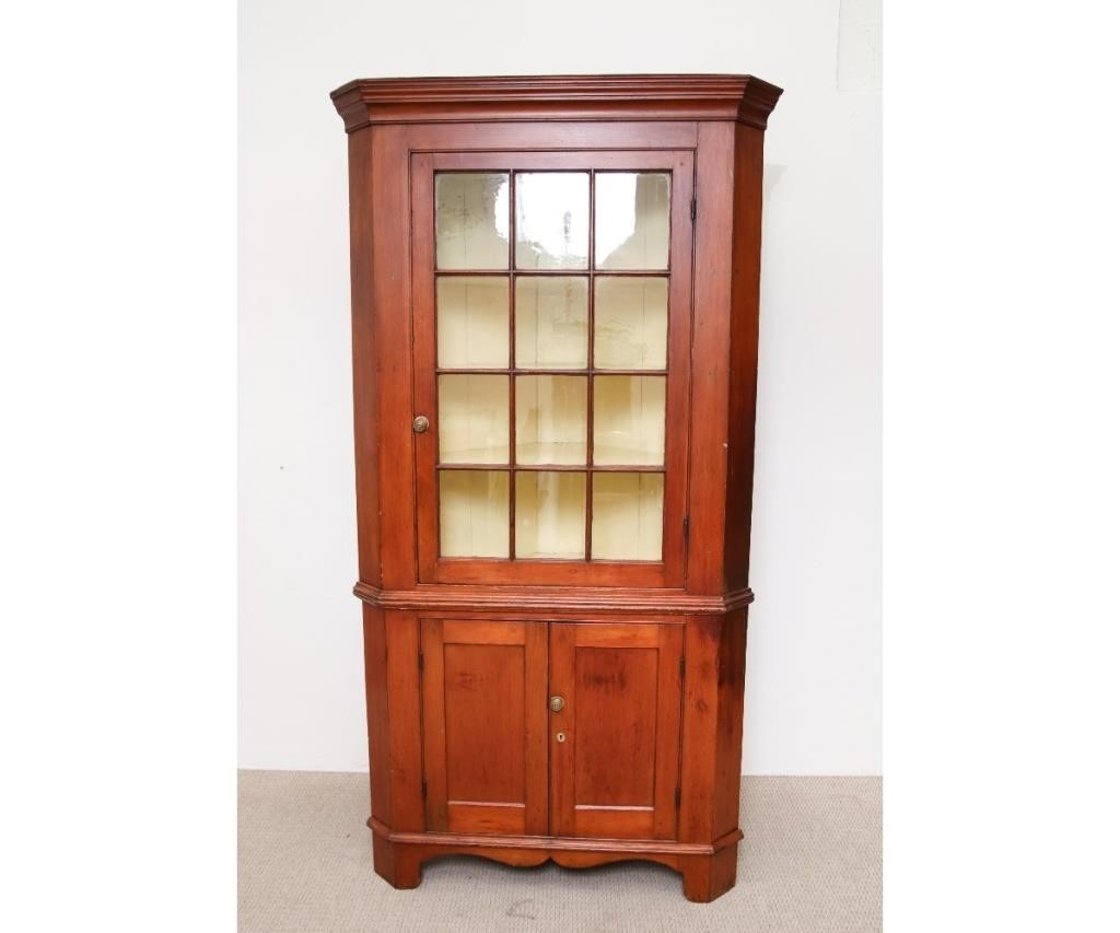 Appraisal: Pennsylvania pine two-piece corner cupboard circa with moulded cornice above